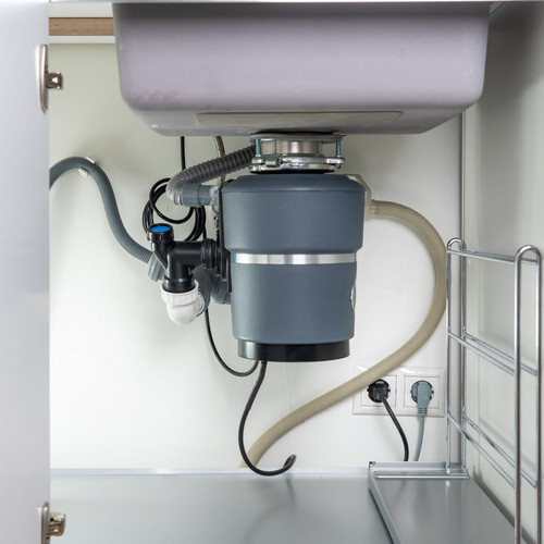 a garbage disposal under a kitchen sink
